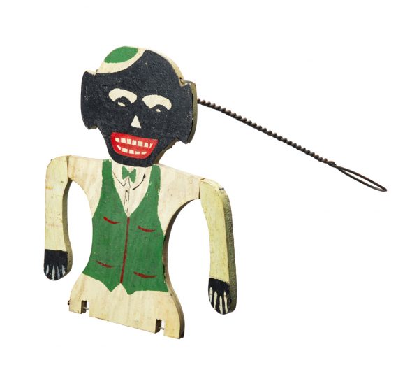 A happy man with white shirt, hat and pants, green vest, but no legs. He has a twisted wire handle