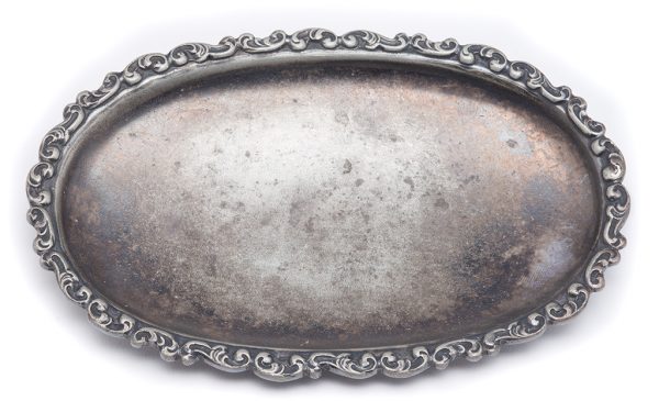 A oval tray, plain with a scroll border around the rim.