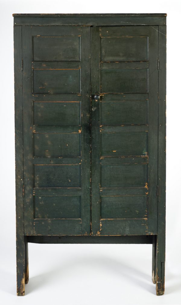 Two-door, raised panel, green cupboard. There are four shelves inside.