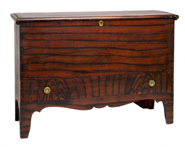 Red and dark brown faux-wood grained painted blanket chest with one drawer.