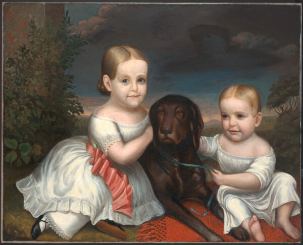 Two toddlers and a black dog on a red rug.