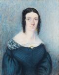 A portrait of a woman wearing a blue dress with a gold brooch at the center of the neckline. The dress has a white lace collar. Her hair is dark with ringlets at both sides.