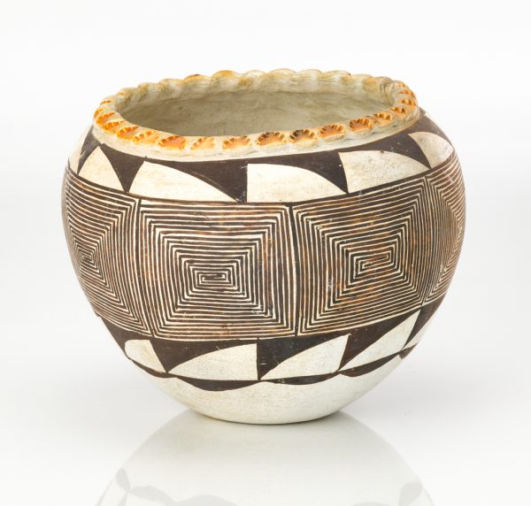 A flat bottom bowl with white slip under a pattern of brown sawtooth at top lip and below belly. The center design is a brown line design of diminishing squares.