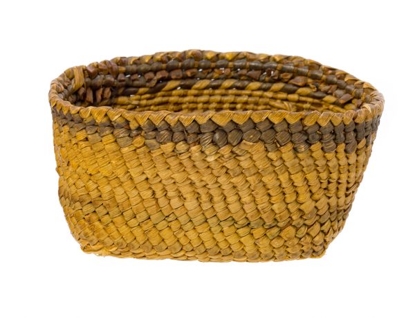 A small twinned basket with flattened rush bottom and one dark band at the top. there is a faded green band at the middle