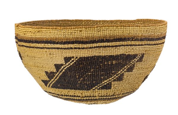Round basket with black on natural background. Top edge is of stripes and the middle has a stepped design. There are three 