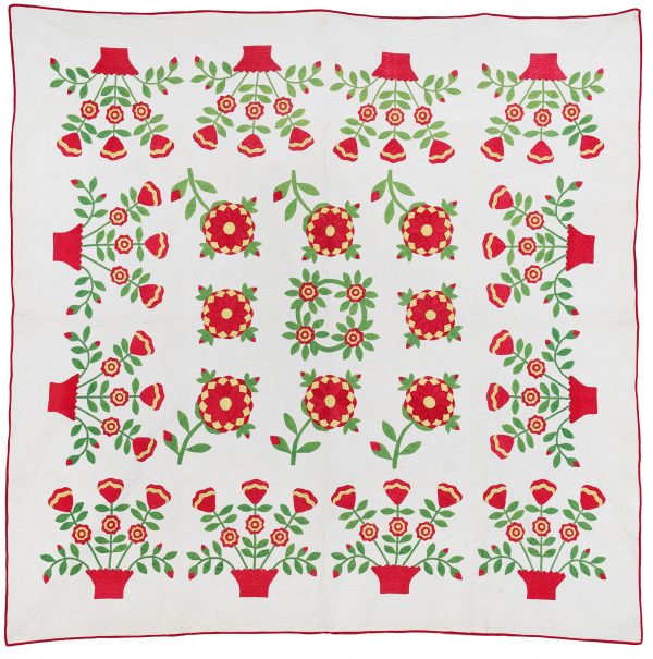 Hand appliqued, hand quilted  in red, green and yellow on white background. The center is in a dahlia pattern with the flowers in a basket along all sides