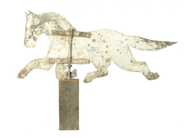 Metal weathervane made from grey sheet metal cut in the shape of a running horse and painted white.