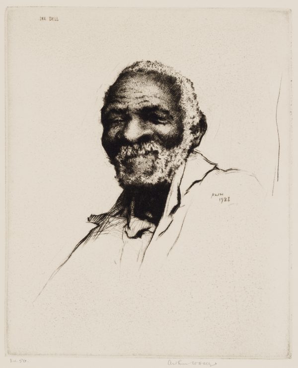 A smiling African-American man with white hair and beard, is shown 3/4 view.