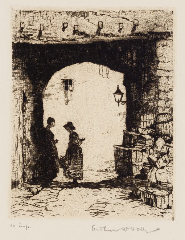 Two women are standing facing each other in the shadow of a arched structure. Baskets are piled to the right side of the arch.