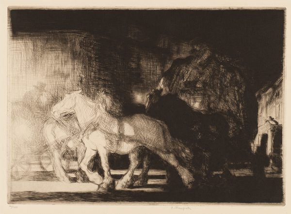 A team of horses pulls a wagon piled high. There is a man sitting on the bench in front of the cargo. Another man wearing a hat is in second cart at the left, this one has a light shining toward the viewer.