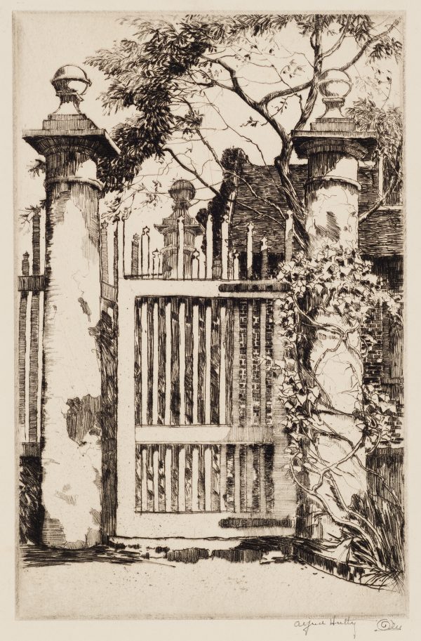 This is an image of 14 Legare Street, Charlston, SC, showing two massive pillars toped with round globes with a vertically slatted gate between and another pillar and house beyond.