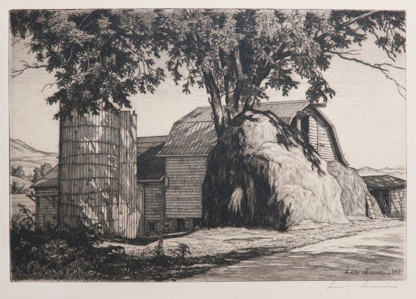 A large hay stack sits outside of a barn with a silo attatched to it. There is a large tree that covers in shade.
