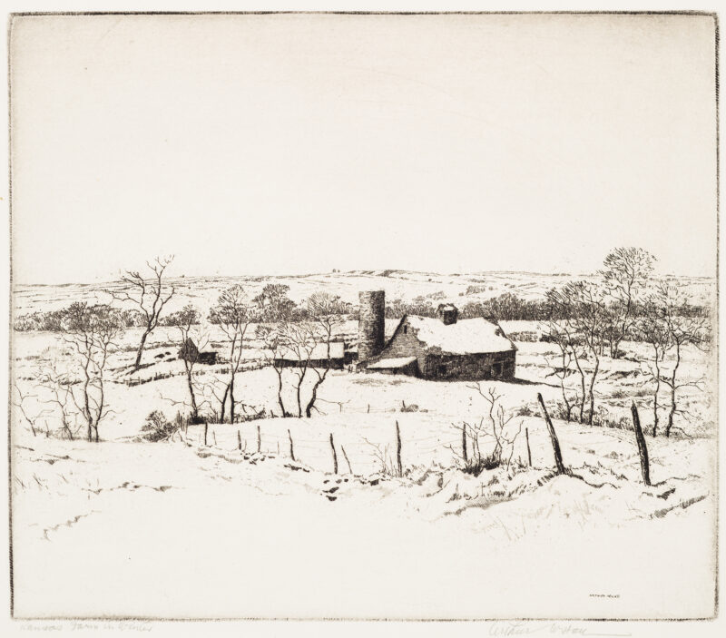 A view of a farm consisting of several buildings and a silo. There is a barbed wire and wood post fence in the foreground with a few small leafless trees scattered throughout.