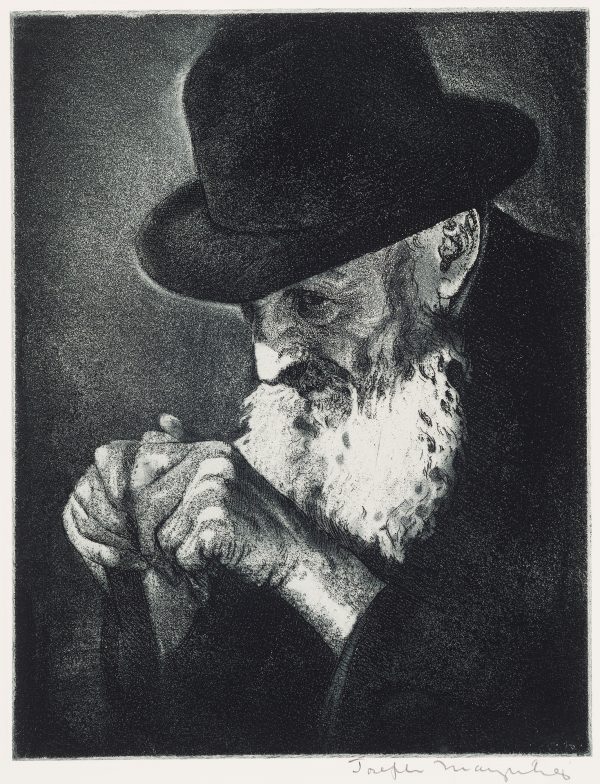 An elderly man with a white beard and a hat is praying, his hands are clenched in front of him.