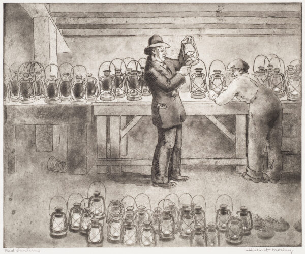 A man lights a lantern and another figure leans against a table full of lanterns. There are also multiple lanterns on the floor.