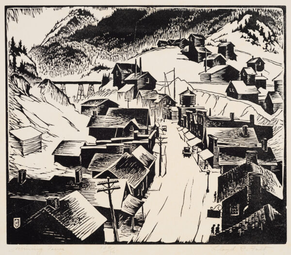A road runs from bottom center toward the top left. A mountain rises in the background and houses are on both sides of the road. A railroad trestle is in the upper left.