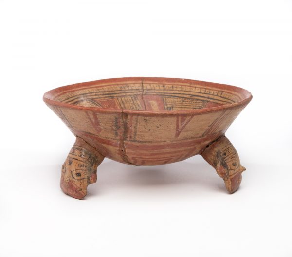 Heads on the tripod legs. This is a rattle bowl. Cream ground with terracotta and black decoration. The design is decorative with dotted lines, hash marks and cross-hatching.