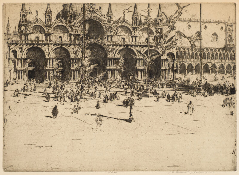 A view of St. Mark's square in Venice. There are multiple figures in the plaza with pigeons flying. The view has the cathedral at the top of the image with the bottom of the image empty.