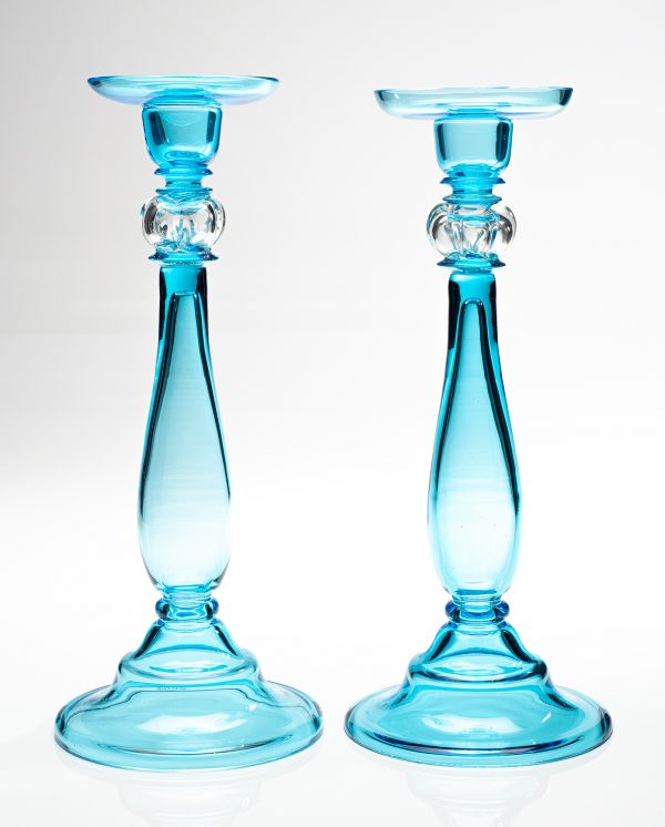 A pair of marina blue and clear candlesticks