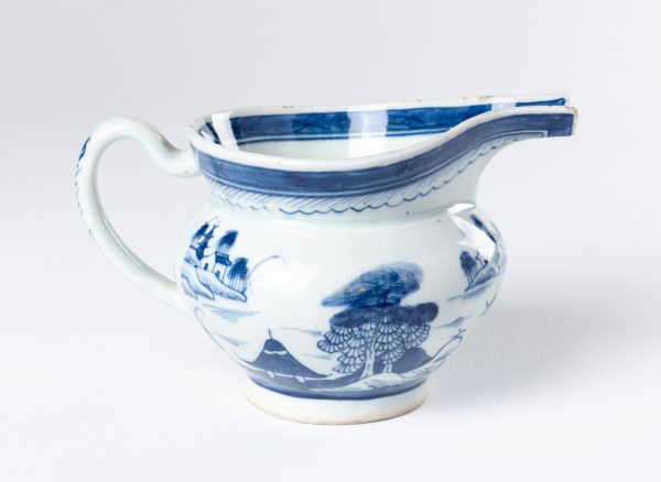 A large creamer in the Blue Willow pattern with open spout