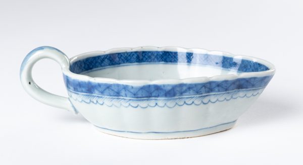 Gravy Boat in the Blue Willow pattern. The exterior has a band of lattice and 