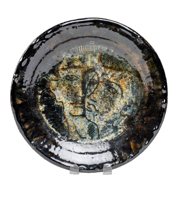 A plate with two faces on it.