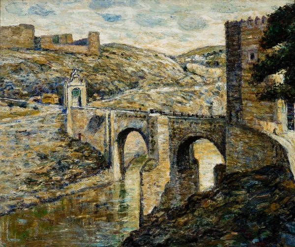 A two arch stone bridge, with tower at right and at end of bridge. The bridge is an entry into Toledo, Spain.