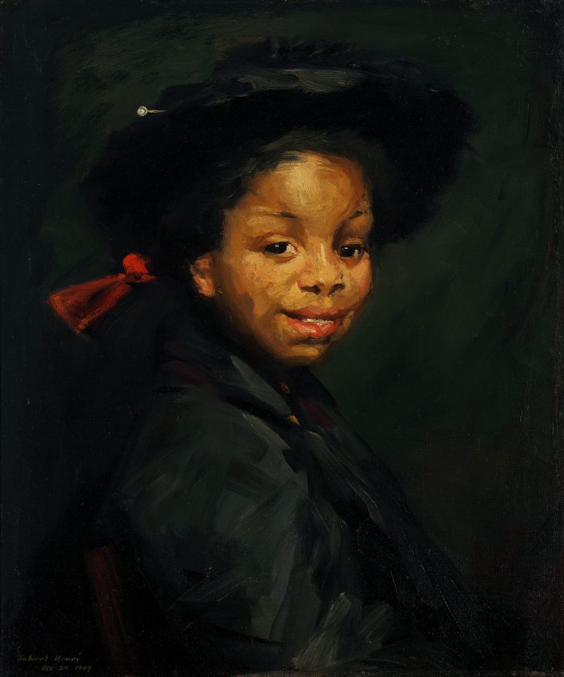 A portrait of a young child with a red ribbon in her hair.