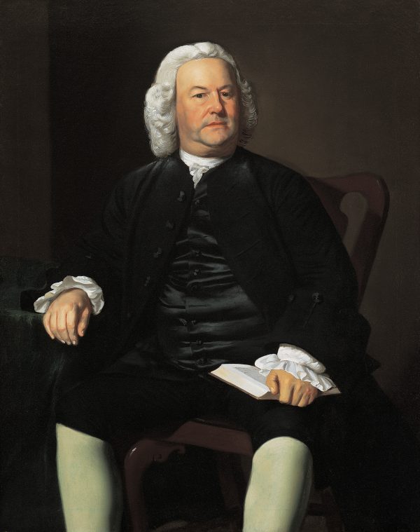 A portrait of a man in a white wig holding an open book. His suit is black with white leggings.