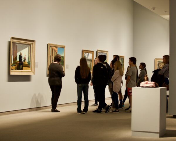 Interior view of the galleries with a docent leading a group of adults on a tour