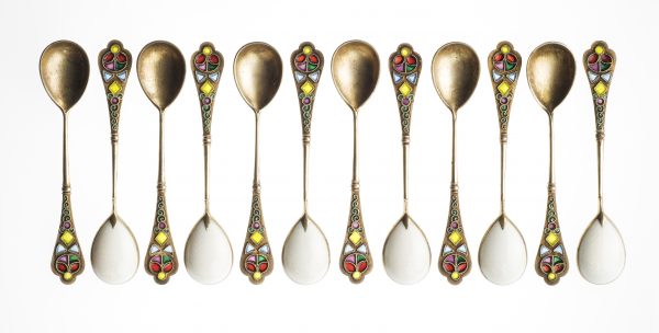 12 golden spoons lined up in a row
