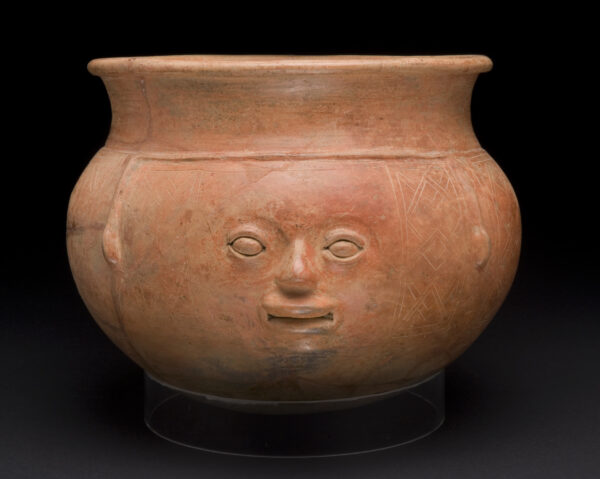 Terra cotta orangish-brown bowl with a human face sculpted on the front