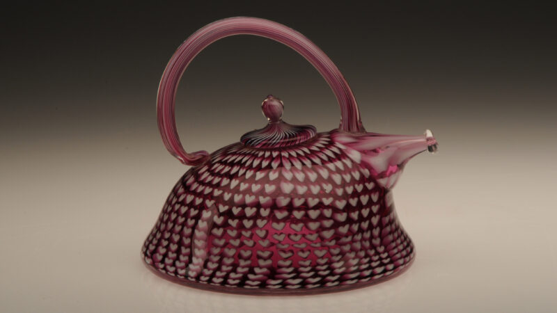 White and raspberry colored fused glass teapot by artist Richard Marquis