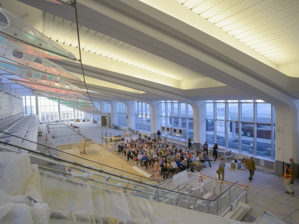 Interior view of the new Wichita Eisenhower Airport terminal with members of the Murdock Society seated in chairs waiting for artist Ed Carpenter to speak