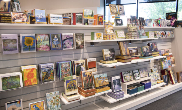 Interior view of the Museum Store with notecards, stationary, and books on display shelves