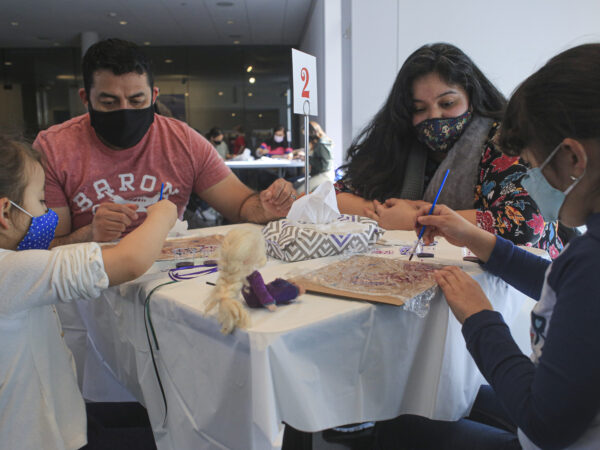 Family doing artmaking activities at a table