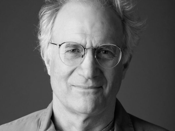 Black and white photo of a man's face with glasses