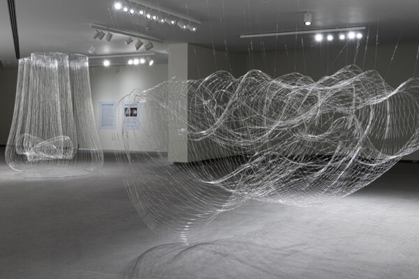 Gallery installation of wire and glass bead sculpture. Large-scale, intertwinning wires.