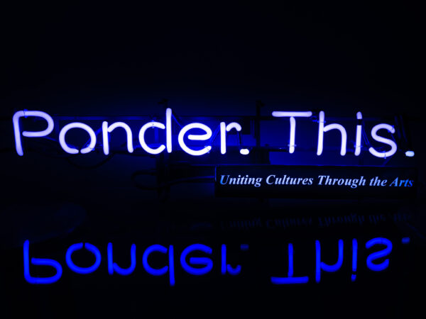 Neon blue text Ponder. This on a black baclground with a mirrored image below the text