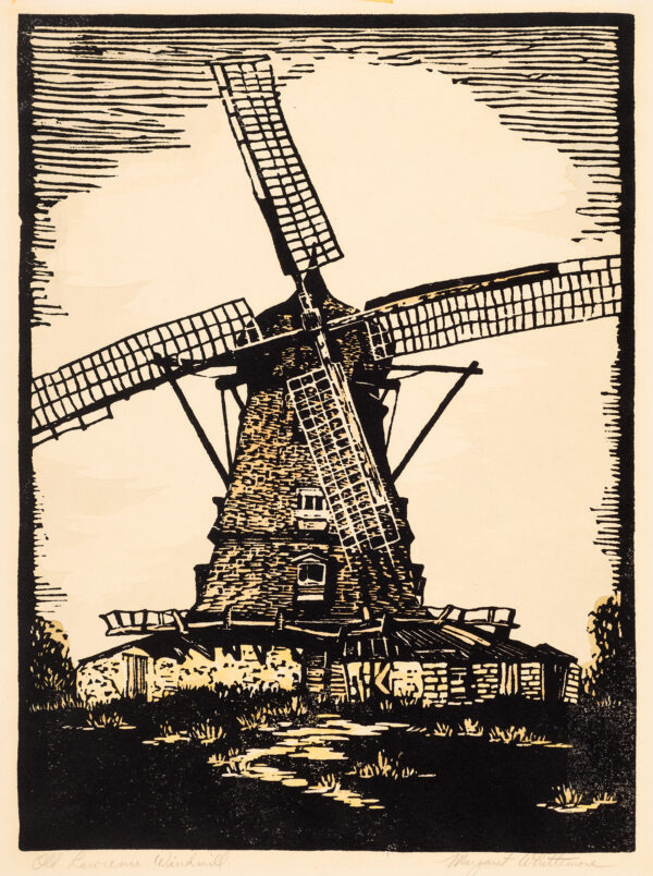 A windmill on a broad base with armature but no canvas in the arms.