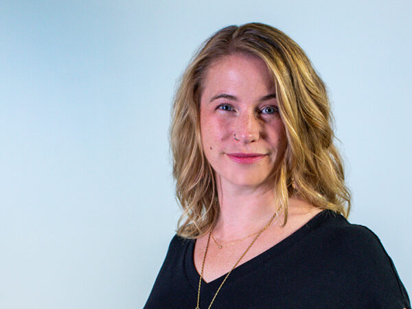 Photo of a woman with blonde hair against a light blue background