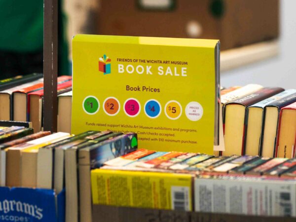 Boxes of books with a price chart in the middle of the photo