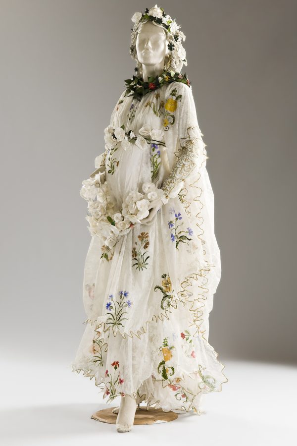 Photo of a paper dress that looks like real fabric in white chiffon with yellow, red and blue flowers on freen stems