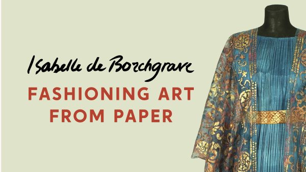 Photo of a paper dress that looks like real fabric in ruffled teal with a gold belt and a sheer gold overlay shawl with a decorative motif; headline title reads Isabelle de Borchgrave: Fashioning Art from Paper