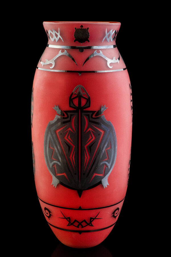 REd vase with black image of a turtle