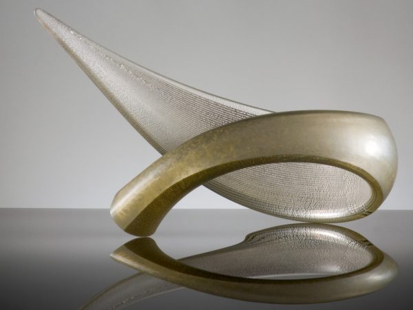 Glass sculpture resembling a curled leaf in gold.