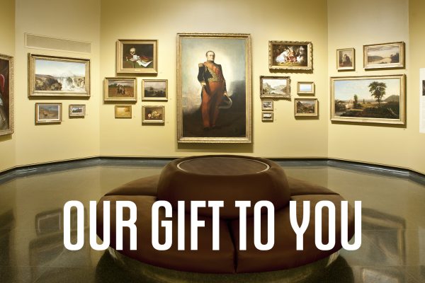 Photo of the Rotunda Gallery with 20 paintings hung salon style on the wall with a round burgundy couch in the foreground