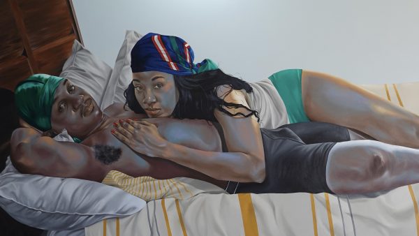 A Black man and a Black woman laying in a bed together