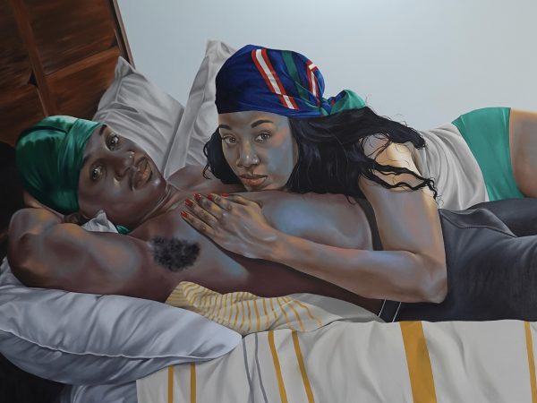 A Black man and a Black woman laying in a bed together