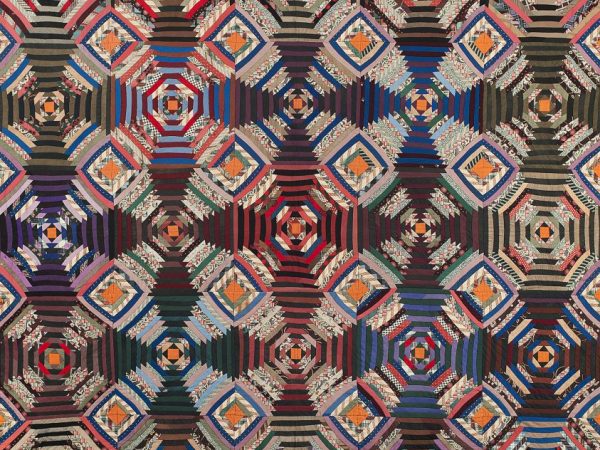 Quilt pattern of geometric shapes resembling a cross in bright colors